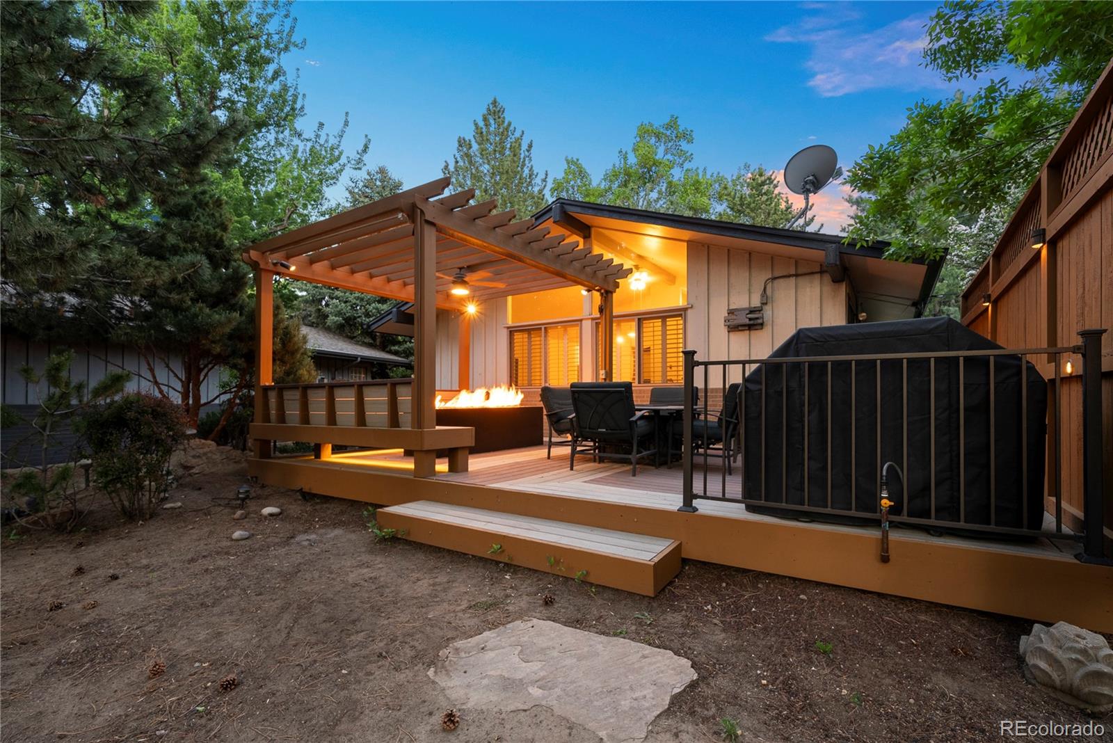 a backyard of a house with barbeque oven table and chairs