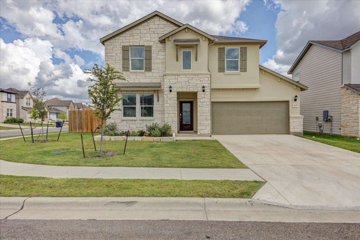 a front view of a house with a yard