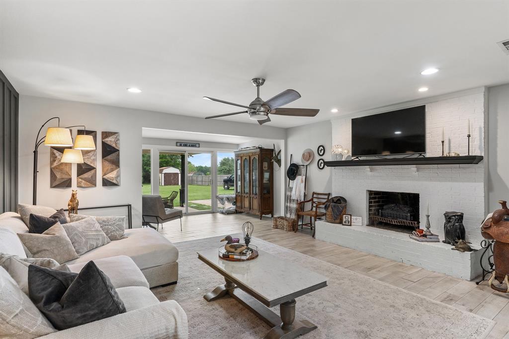 a living room with furniture a fireplace and a flat screen tv