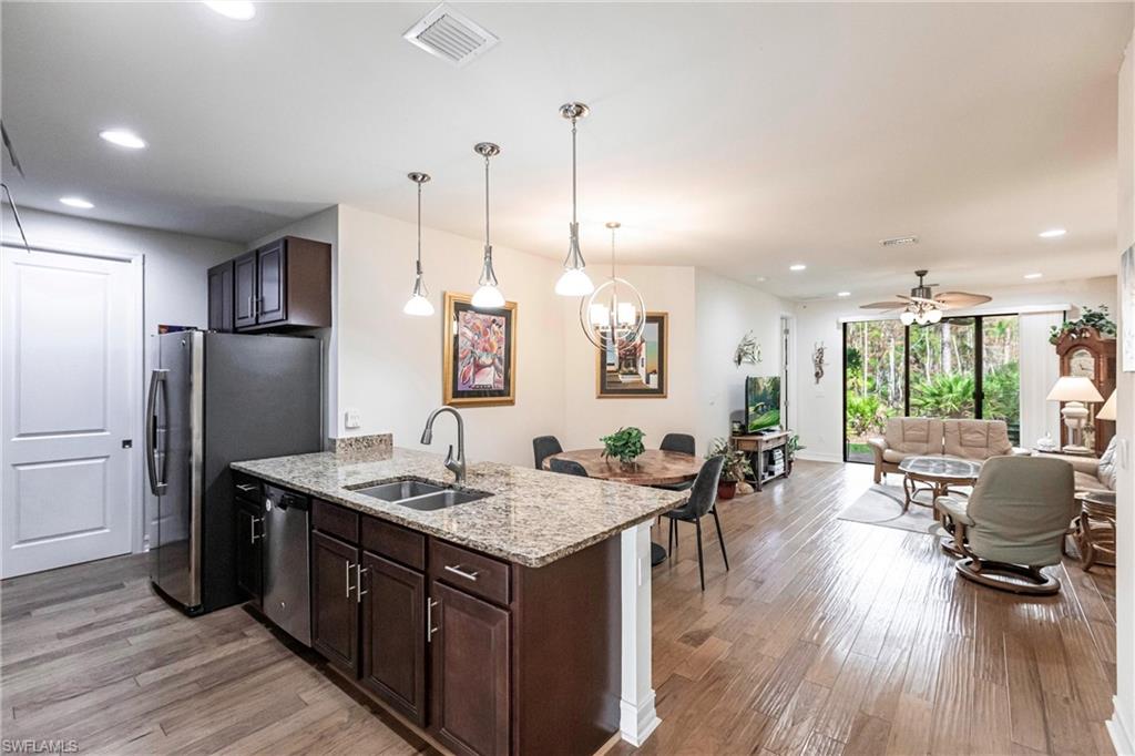 a kitchen with a table chairs refrigerator and microwave