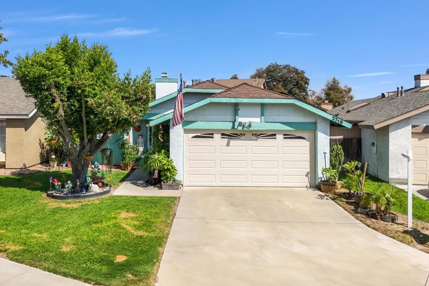 a front view of a house with a yard and garage