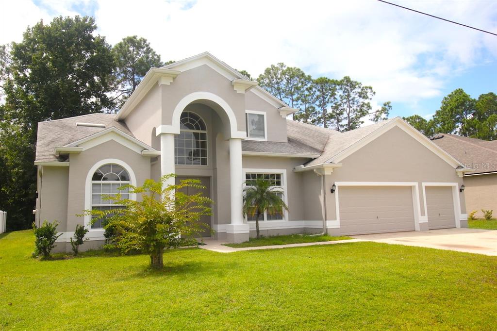 a front view of a house with a yard