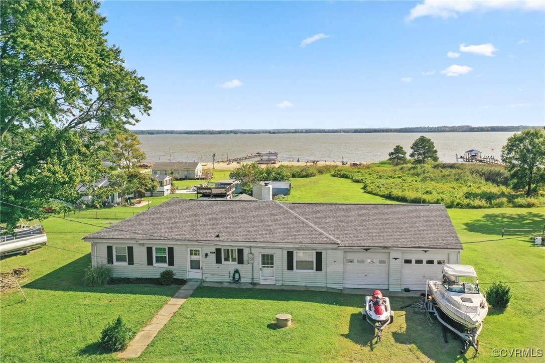 an aerial view of a house with swimming pool garden and outdoor seating