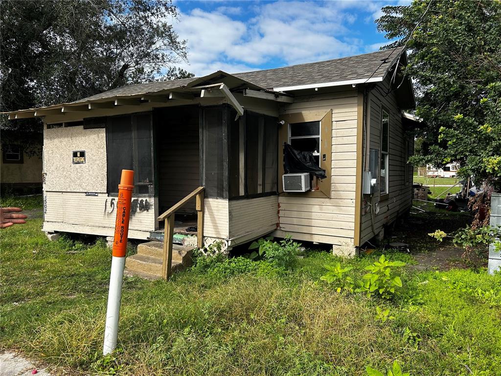 a view of a house with a large window and wooden fence