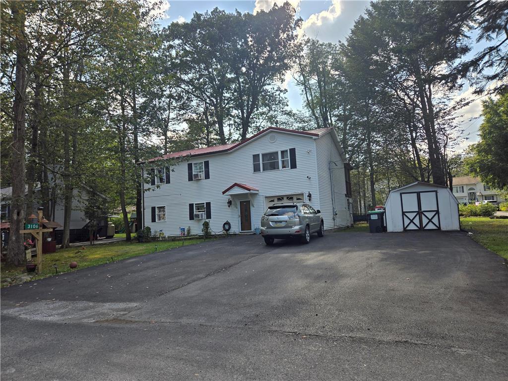 a view of a house with a truck parked in front of a house