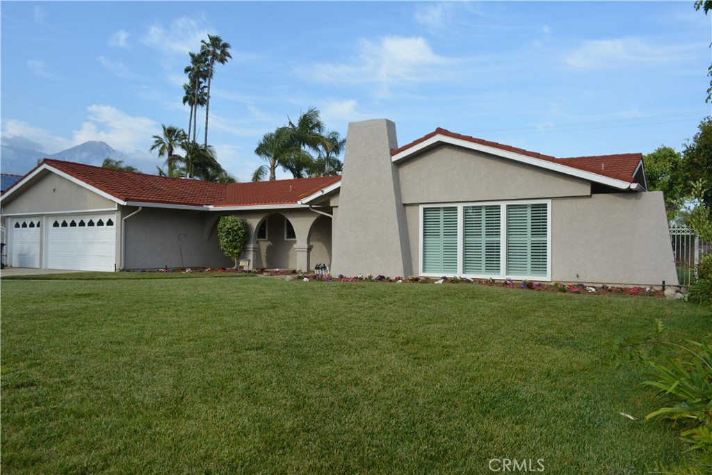 a front view of a house with a garden