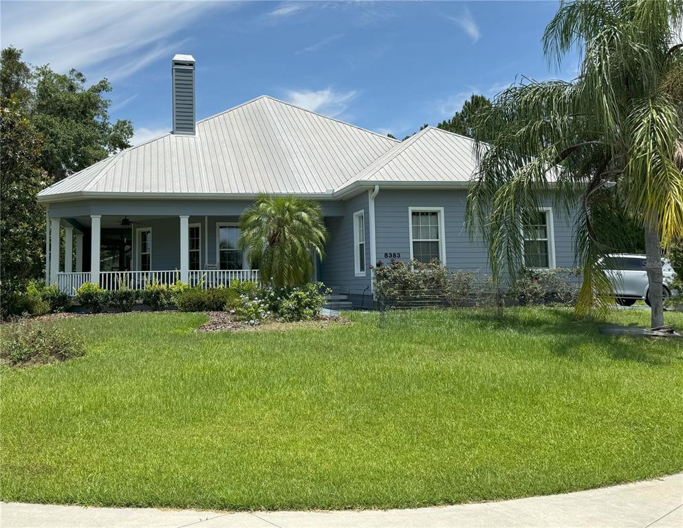 a front view of house with yard and green space