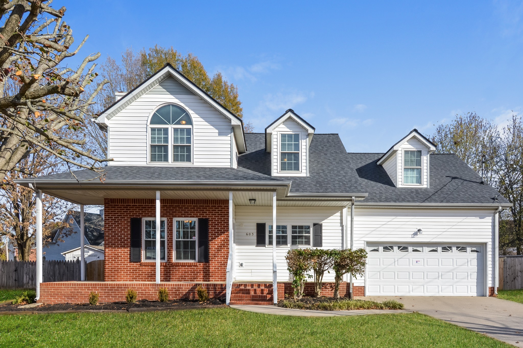 a front view of a house with a yard