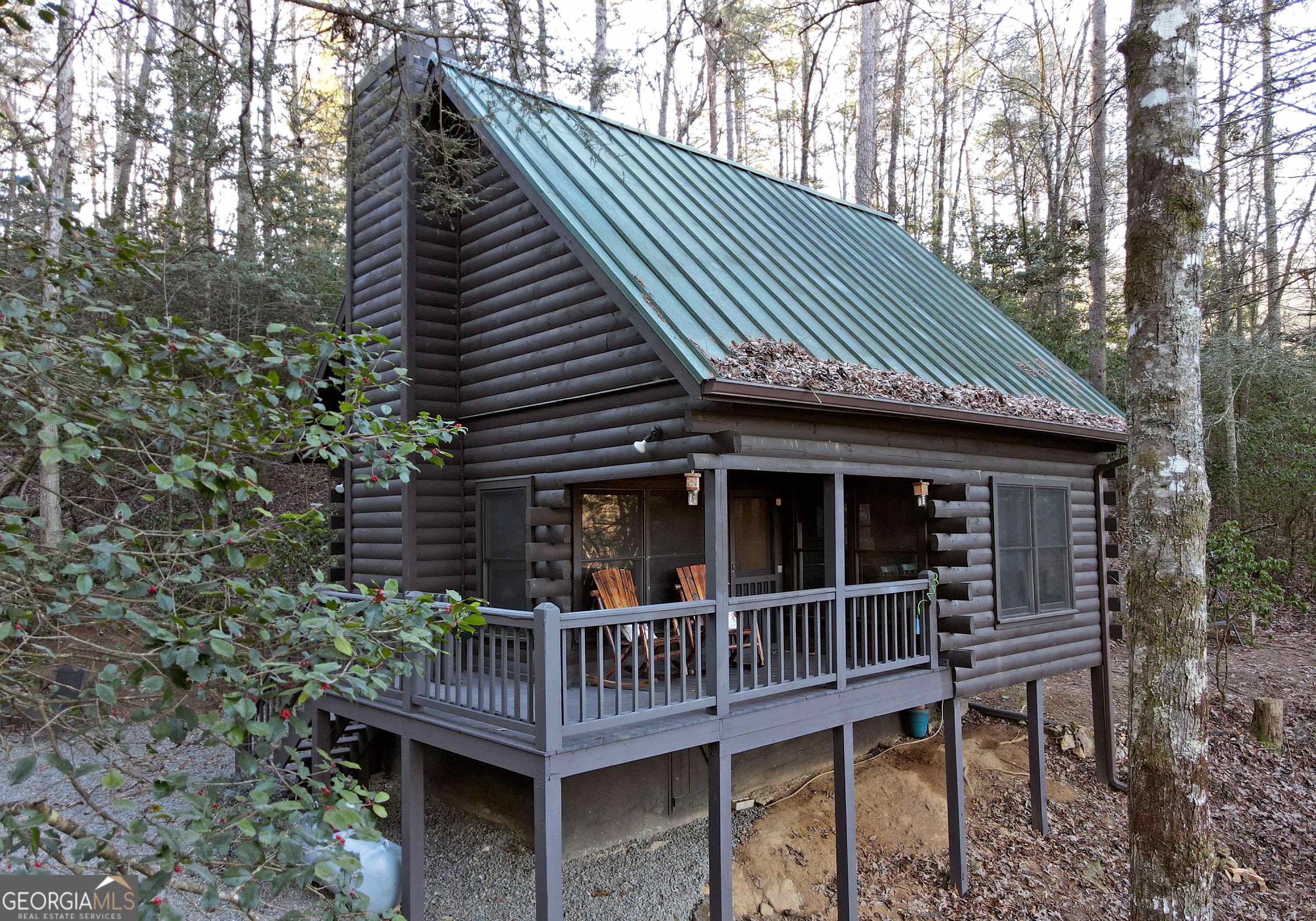 a view of house with a deck and furniture