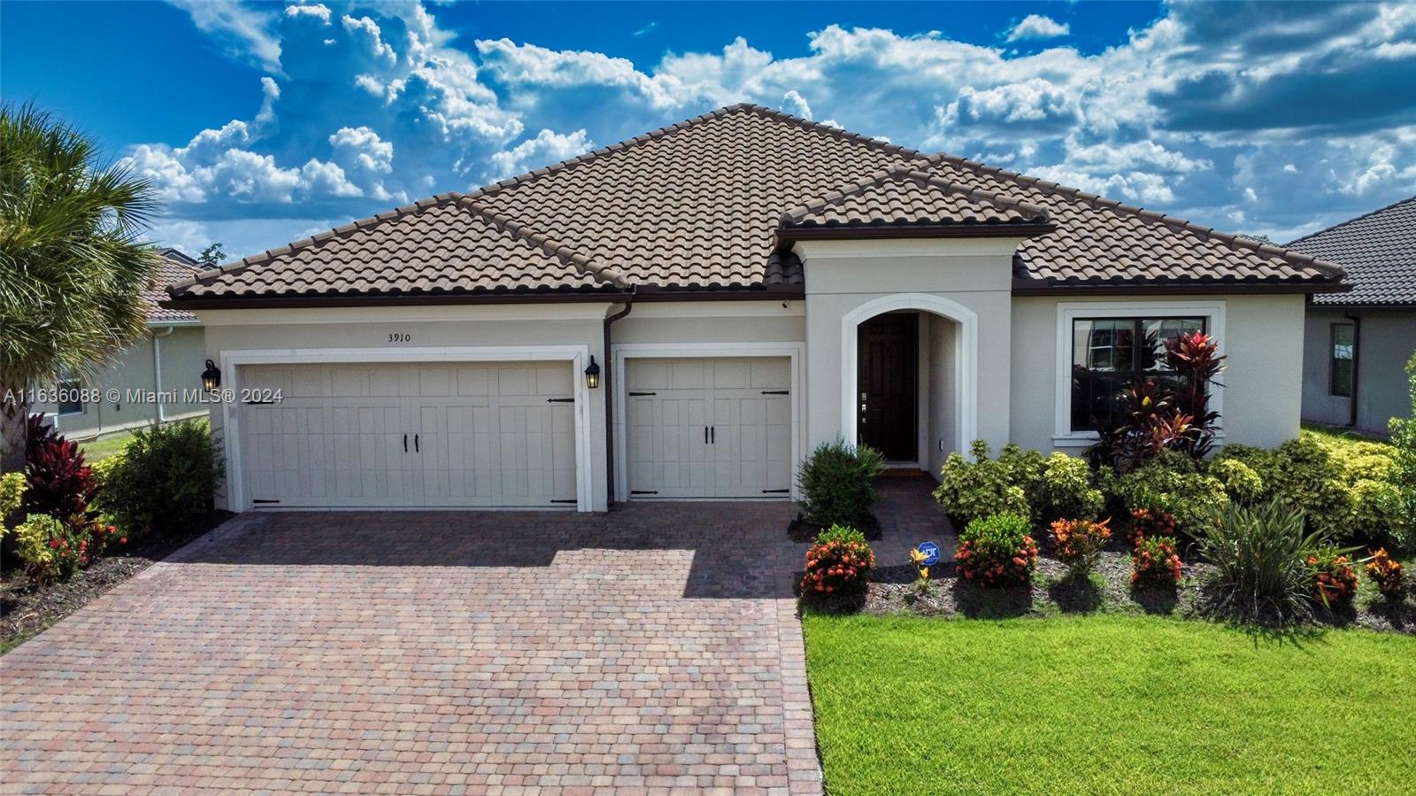 a front view of a house with a garden