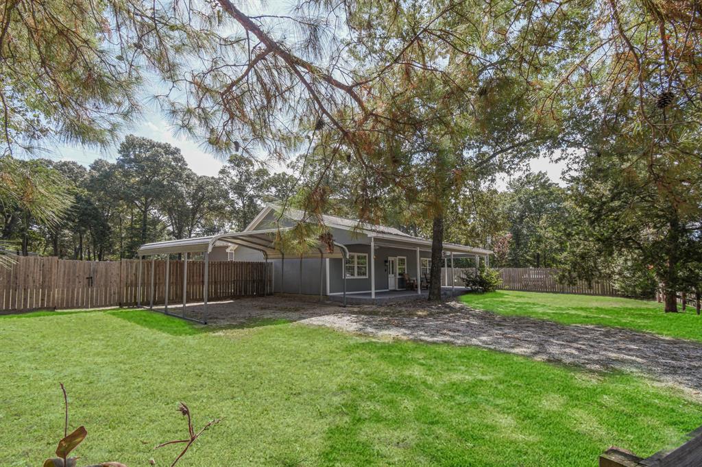 a view of a house with a yard and sitting area