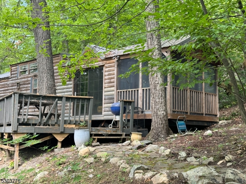 a view of backyard with deck and chairs