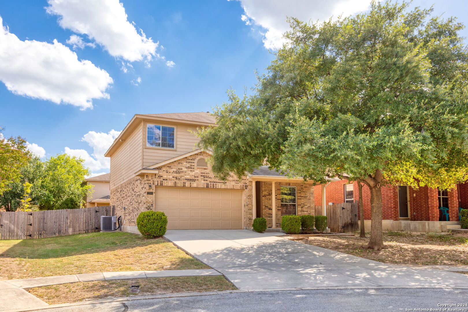 a view of a house with a yard and tree s