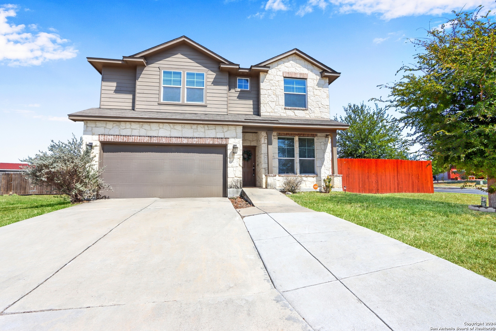 a front view of a house with a yard and garage