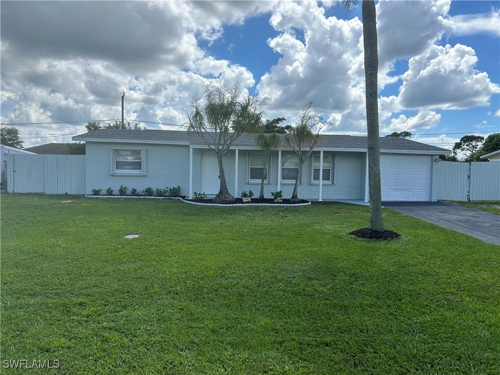 a front view of house with yard and green space