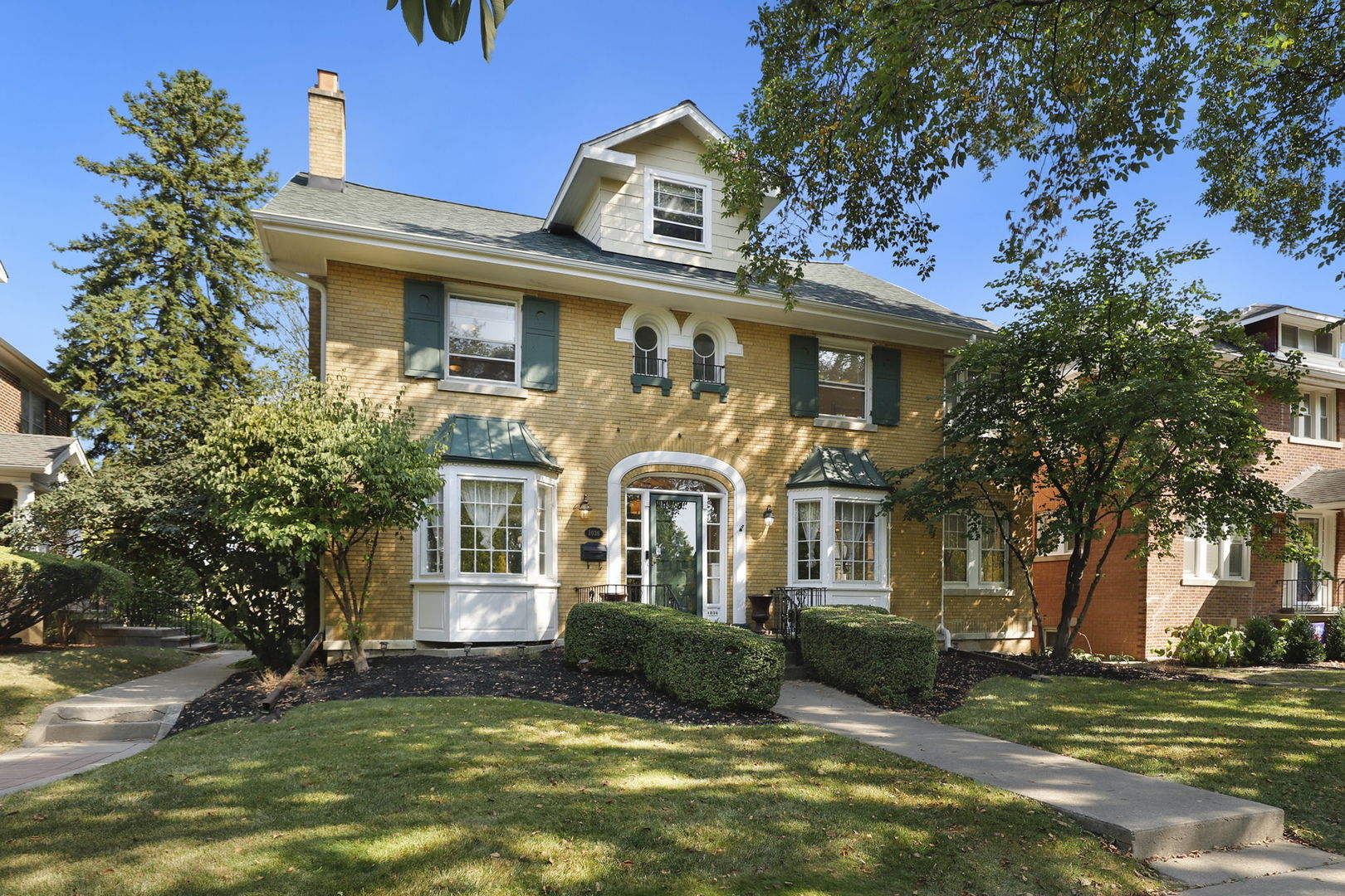 a front view of a house with a garden