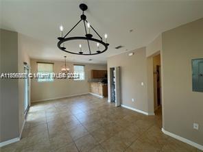 a view of a livingroom with furniture and chandelier fan