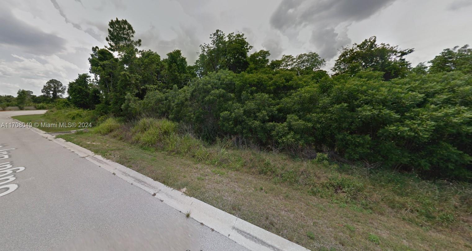 a view of a wooden fence next to a yard