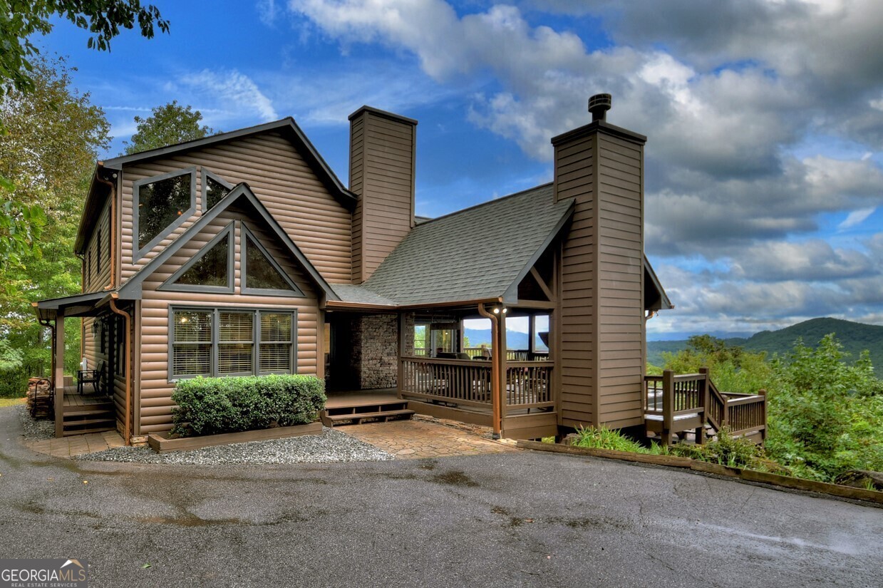 a view of a house with wooden fence