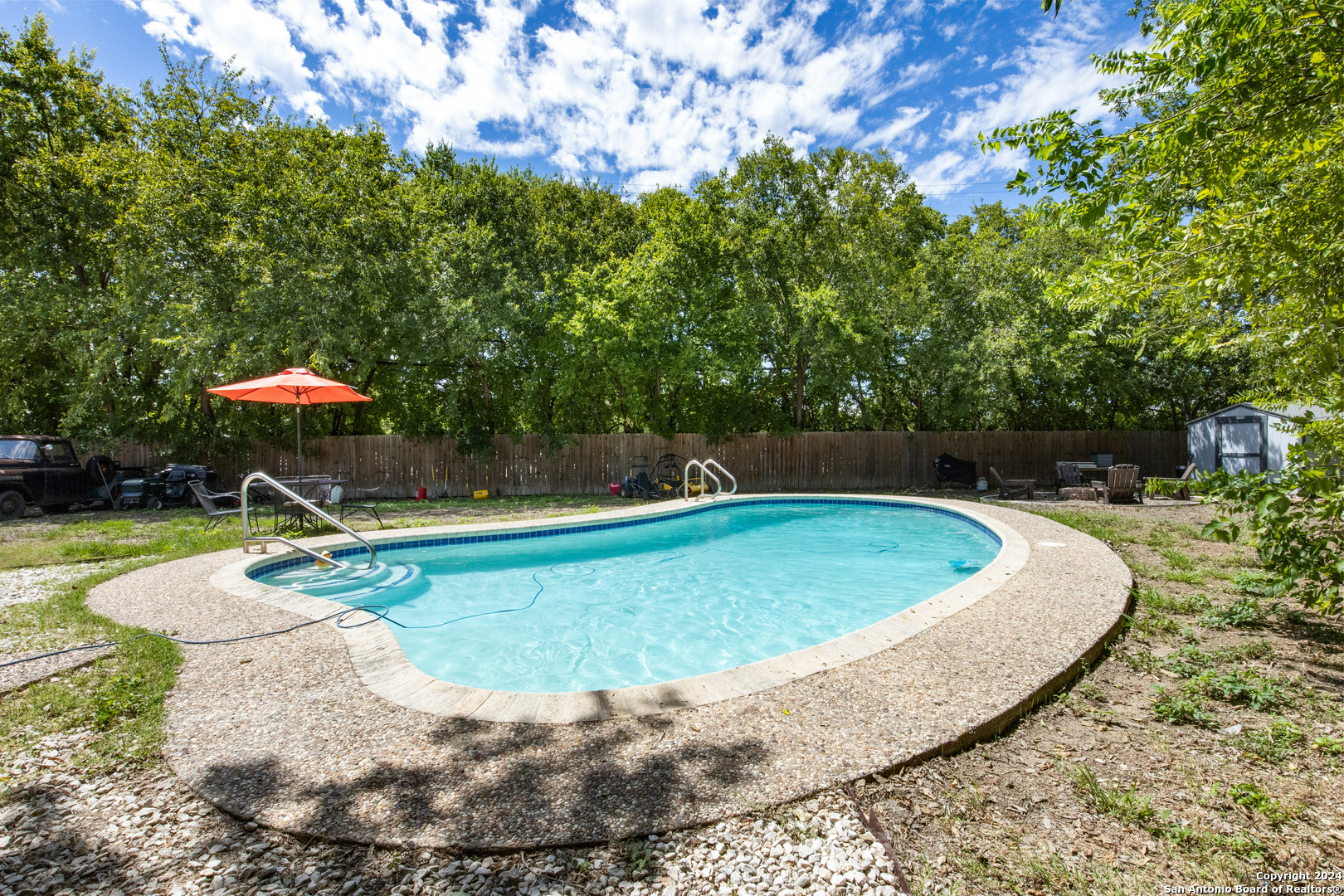 a view of a swimming pool with a yard