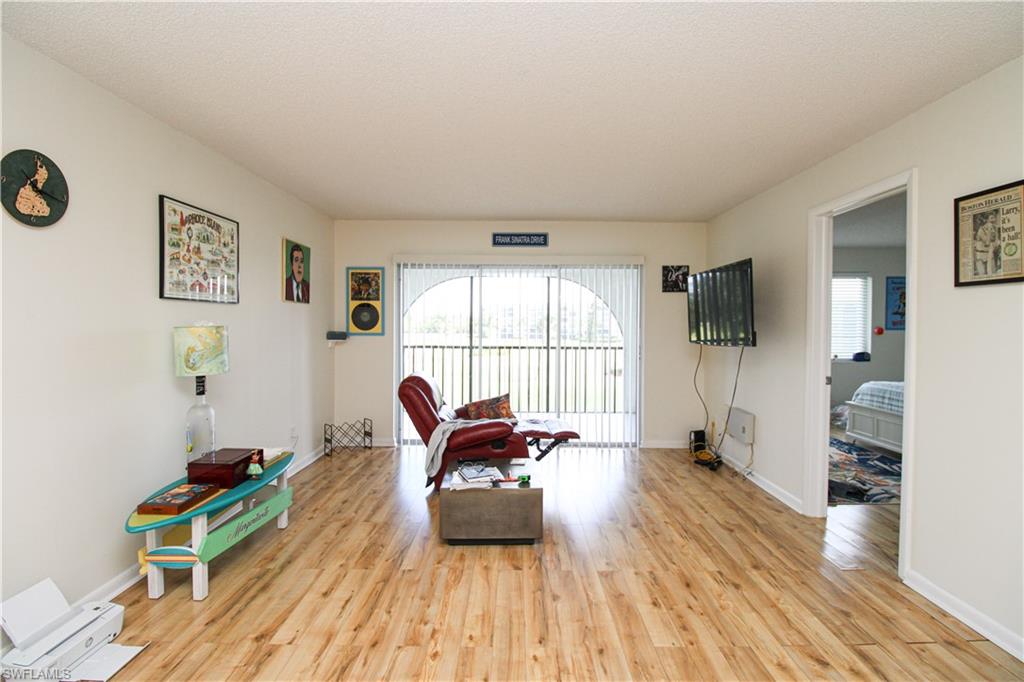 a room with furniture a rug and a window