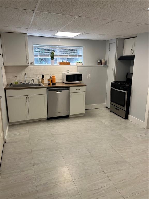 a kitchen with granite countertop a sink and a stove top oven