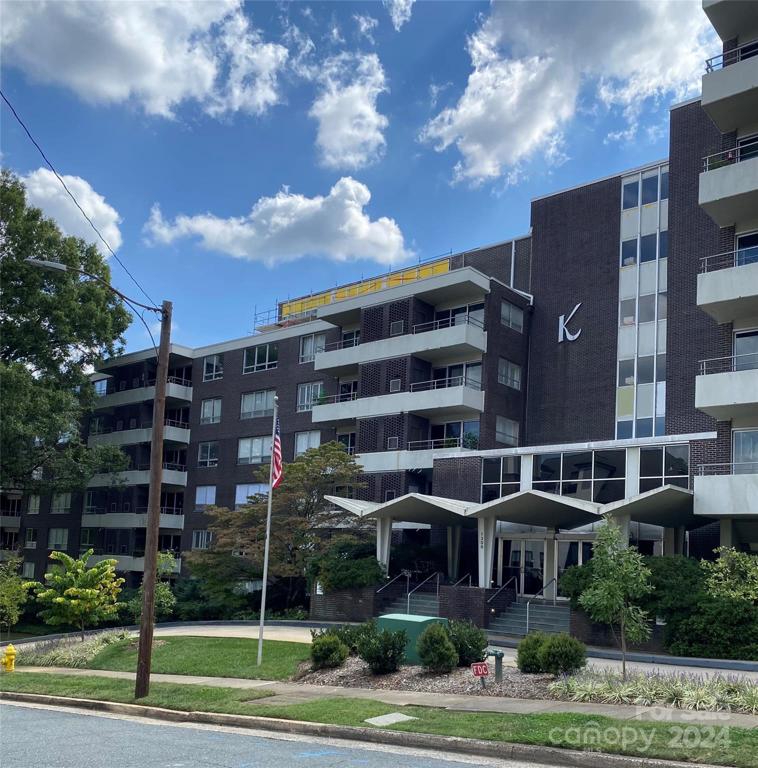 a view of a building with a yard