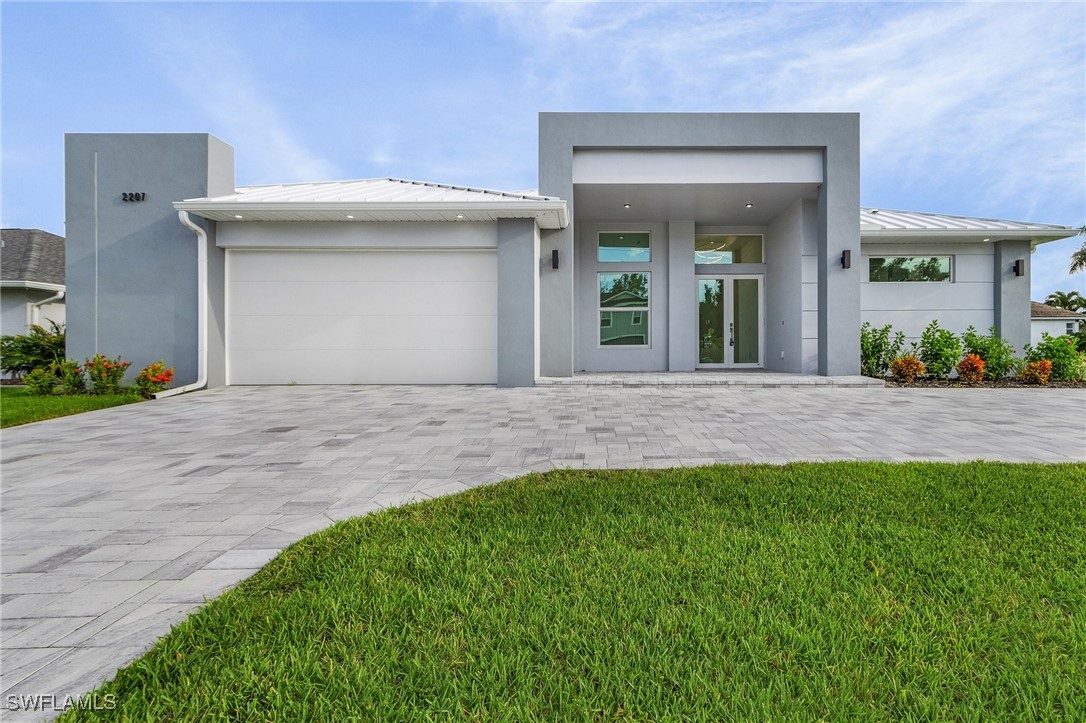 a front view of a house with a yard and garage