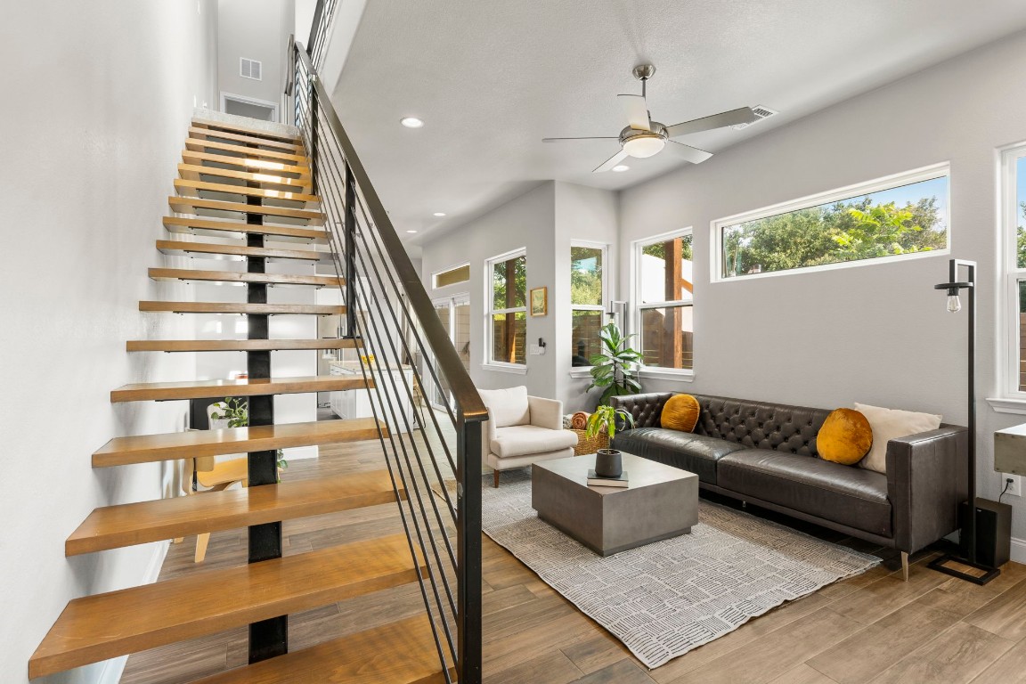 a living room with furniture and a potted plant