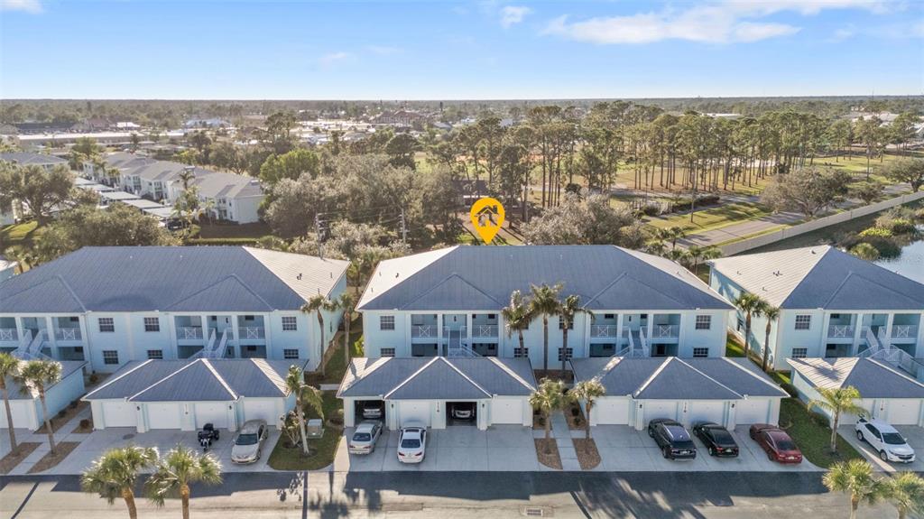 an aerial view of houses with yard