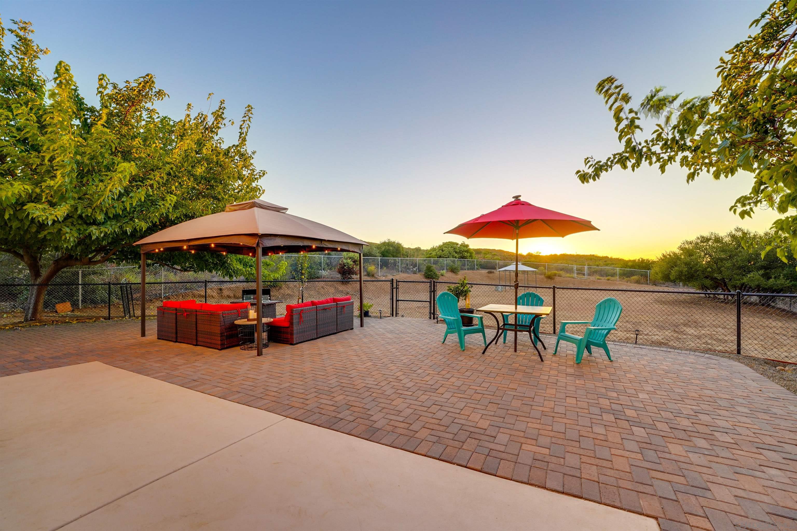 an outdoor space with furniture and umbrella