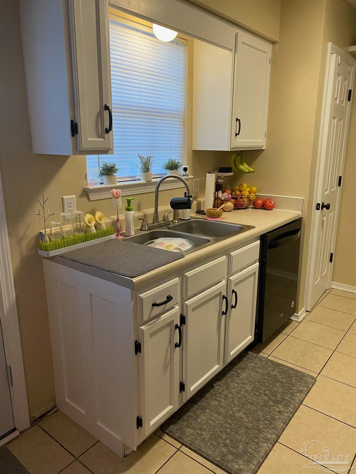 a kitchen with white cabinets sink and white appliances