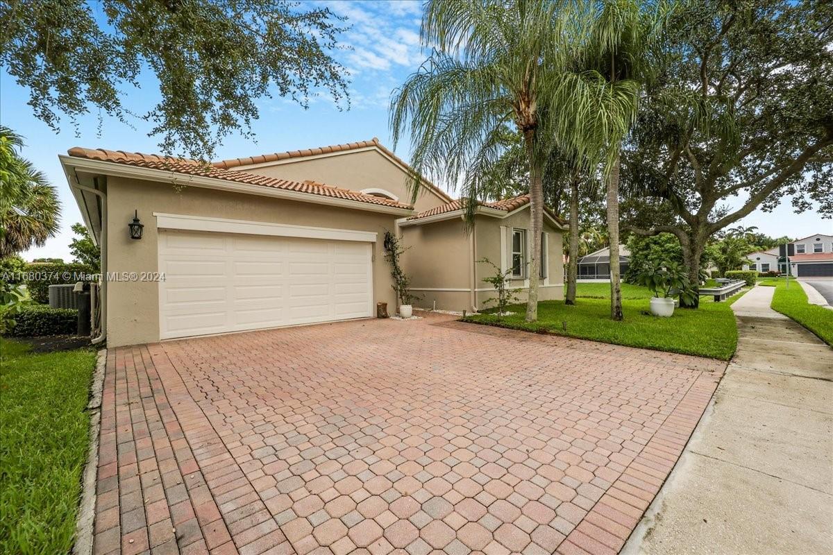 a front view of a house with a yard and a garage