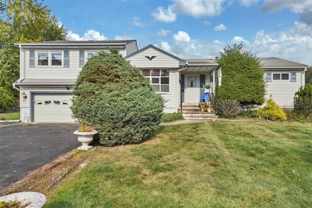 View of front facade with a front yard and a garage