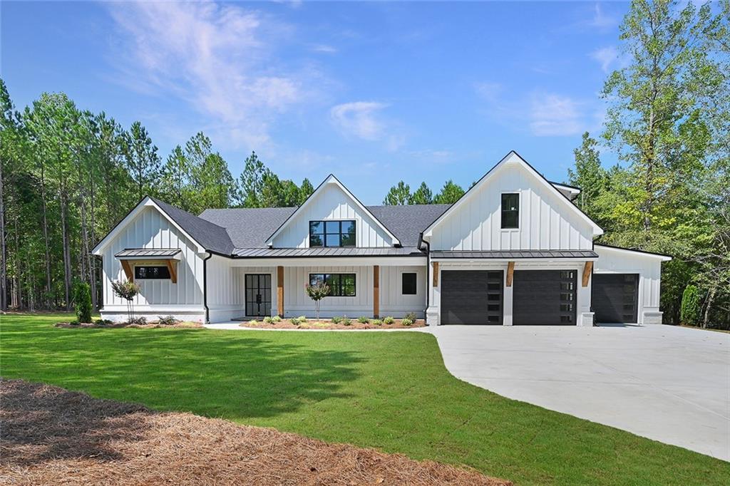 a front view of a house with a garden and trees