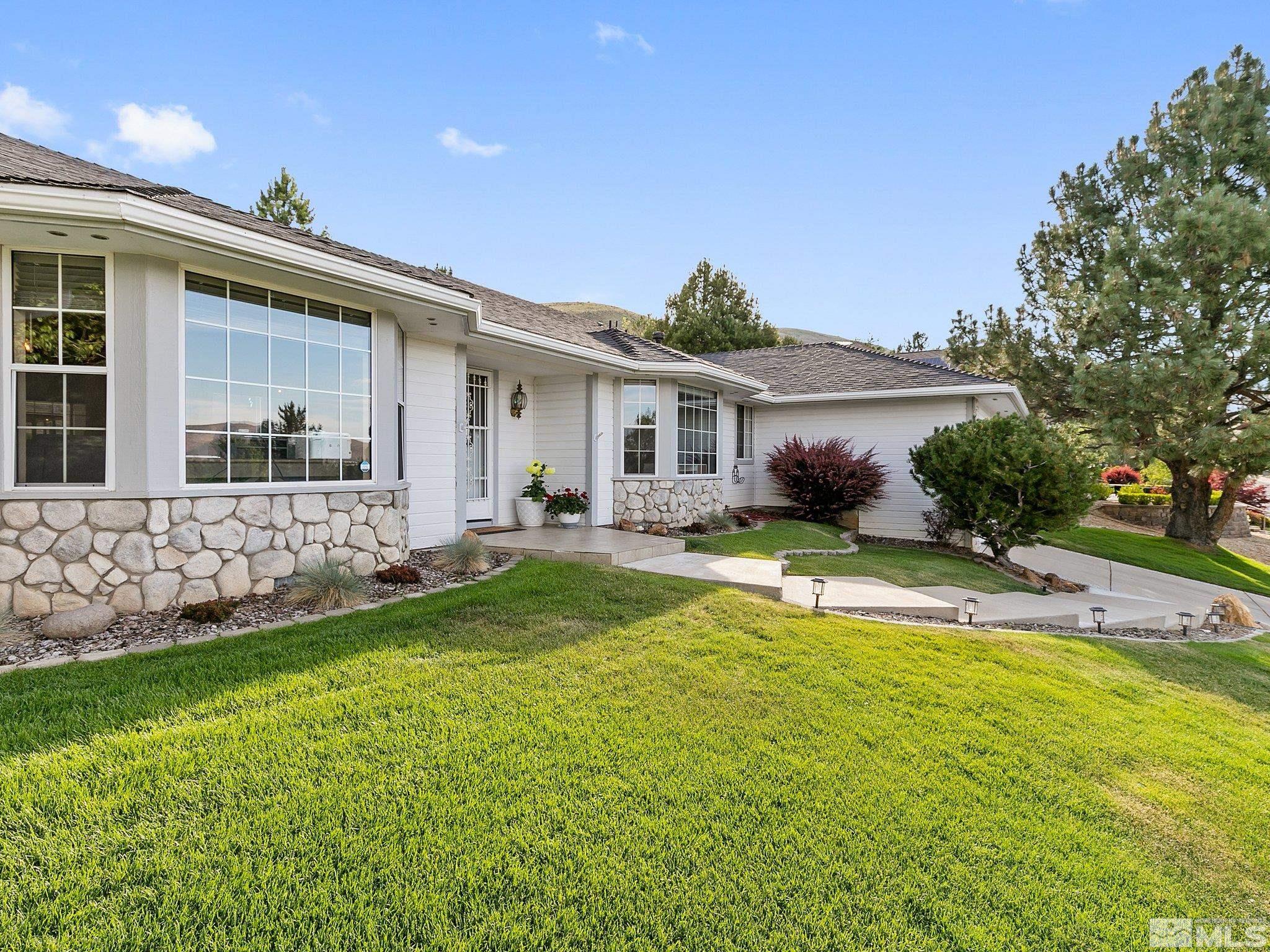 a view of house with yard outdoor seating and swimming pool