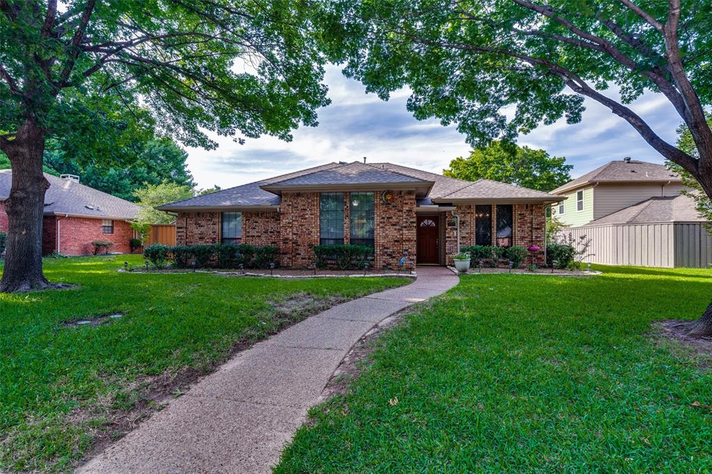 a view of house that has a yard