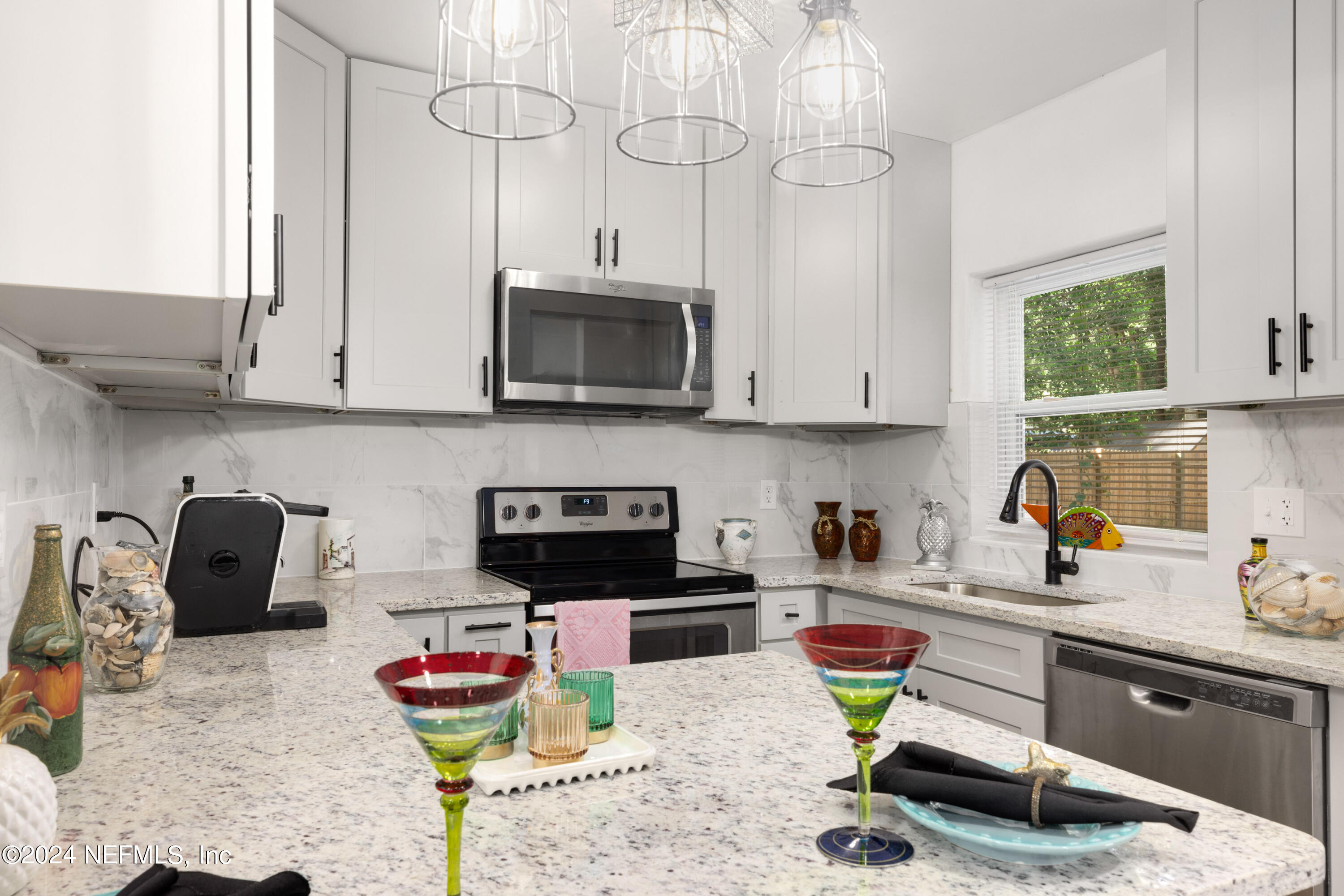 a kitchen with stainless steel appliances granite countertop a sink and cabinets