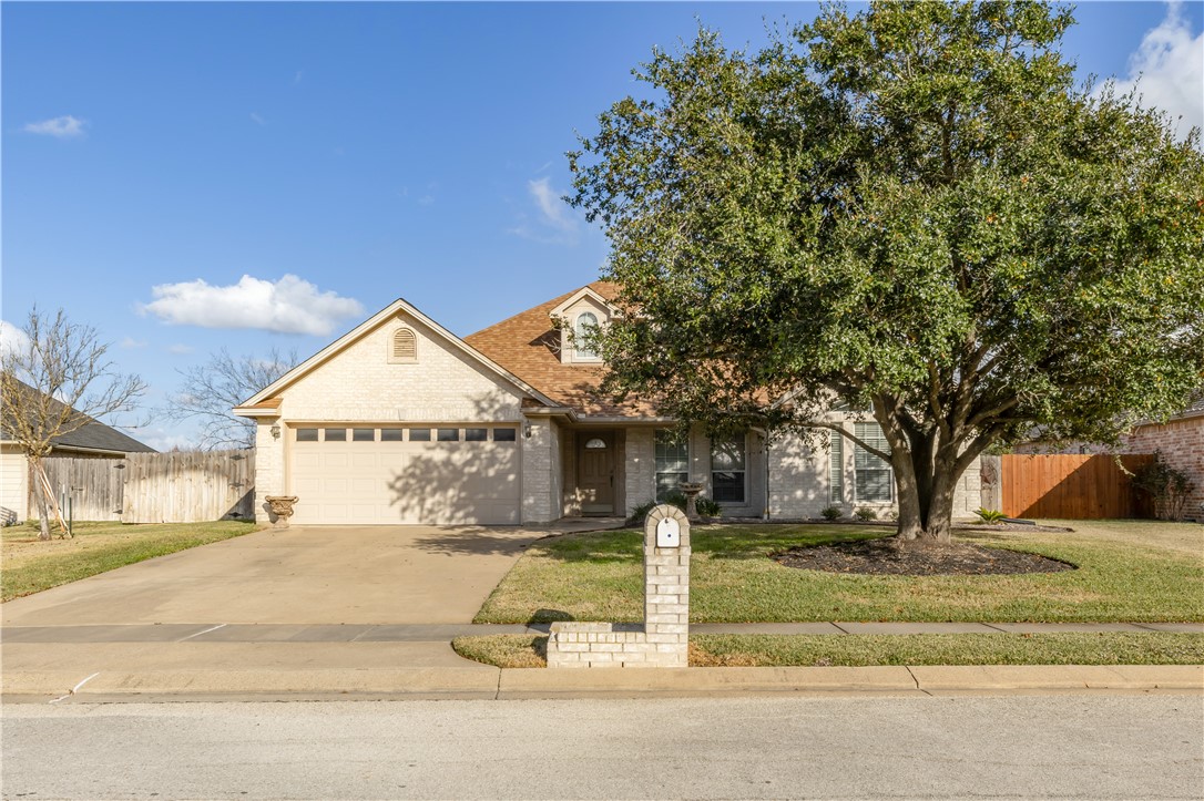 View of front of property featuring a garage and a