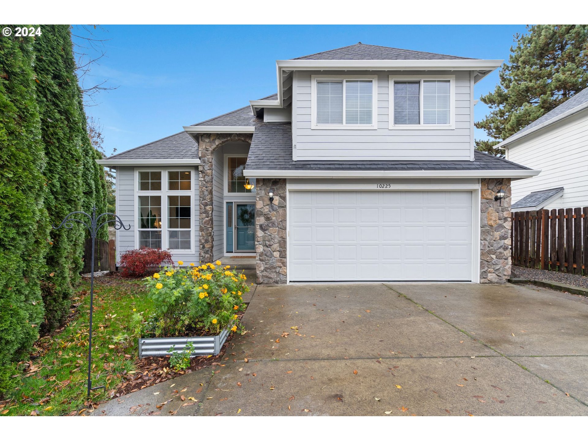 a front view of a house with a yard and a garage