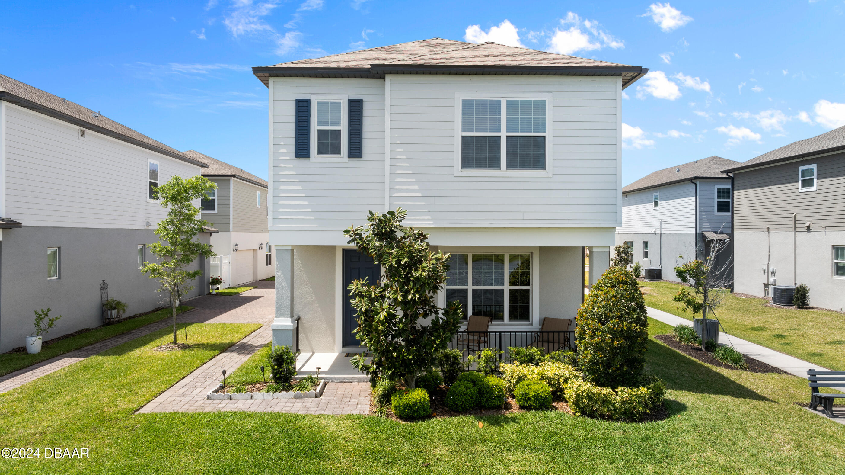 a front view of a house with garden