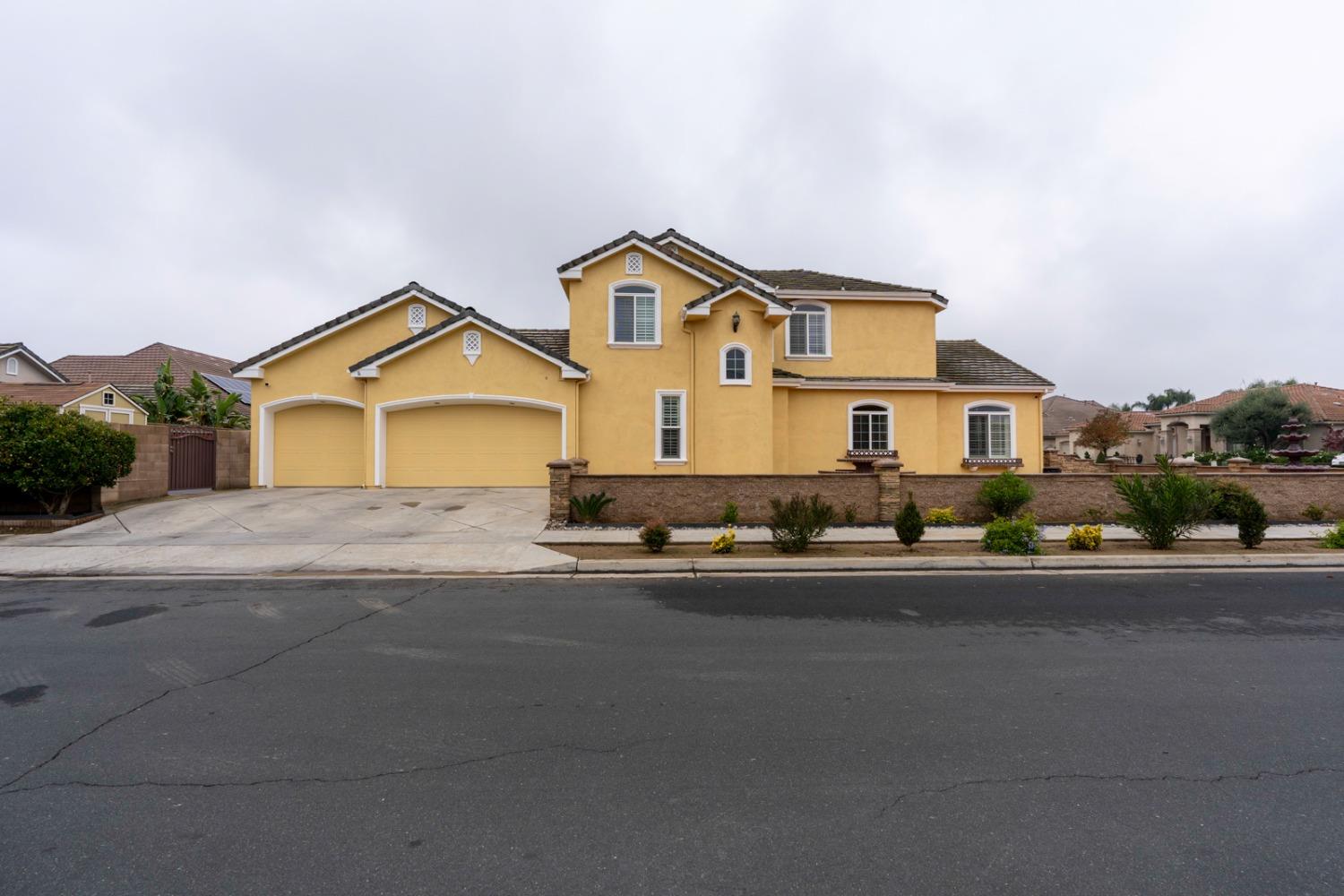 a front view of a house with a yard and street view