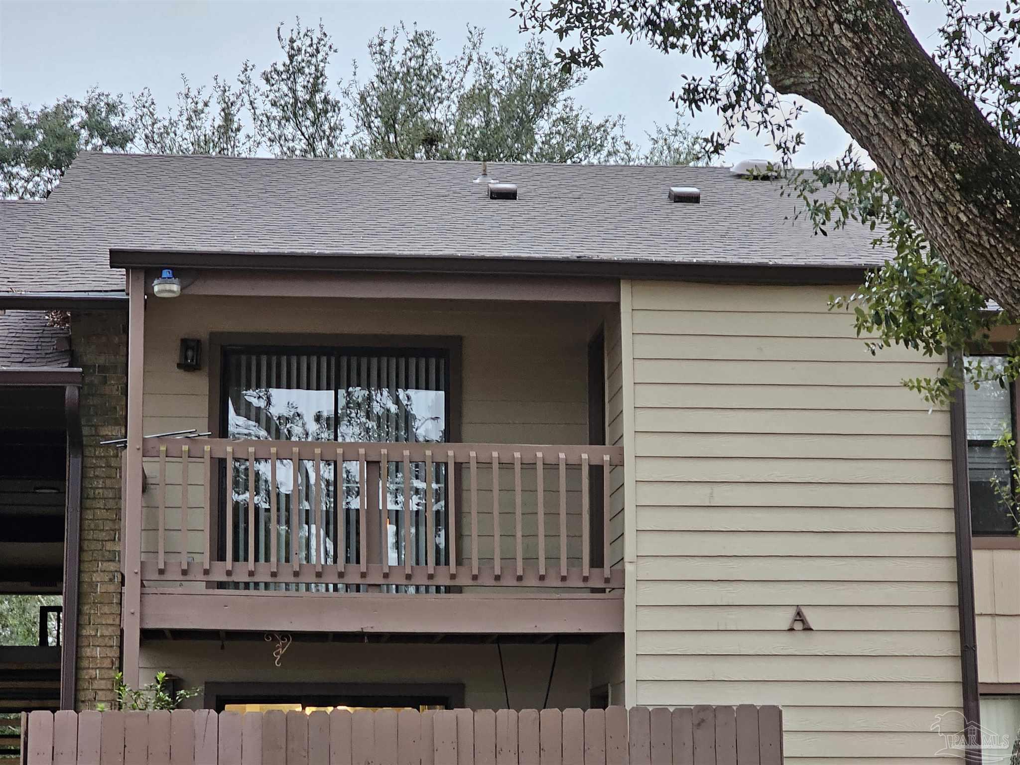 a view of house with deck and a garden