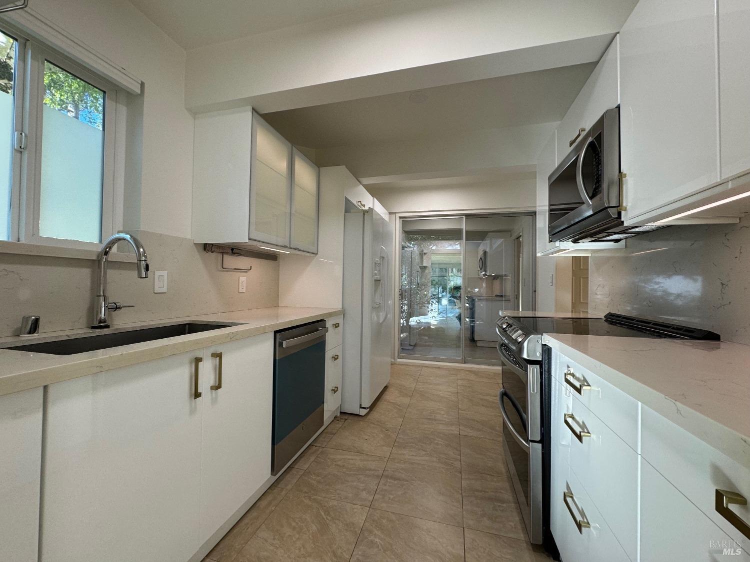 a kitchen with a sink stove and cabinets