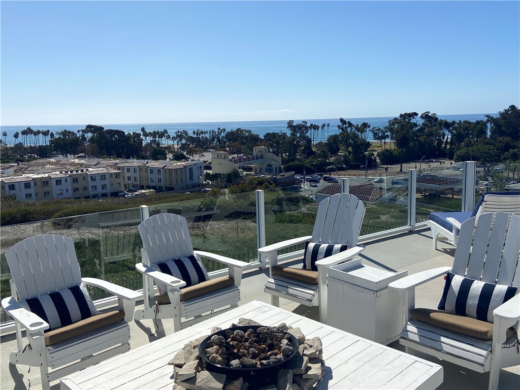 a view of a roof deck with couches and wooden floor