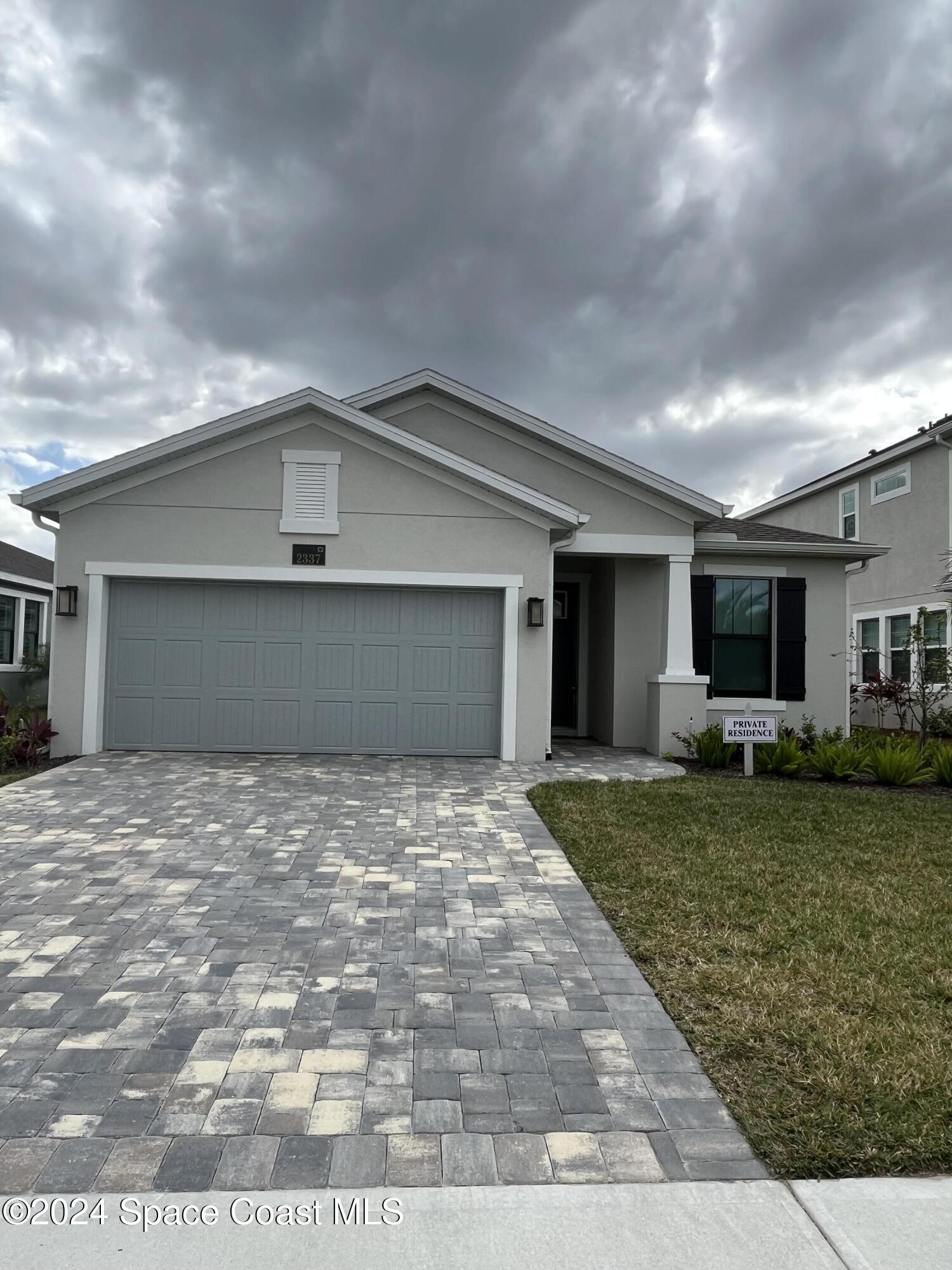 a view of a house with a yard and garage