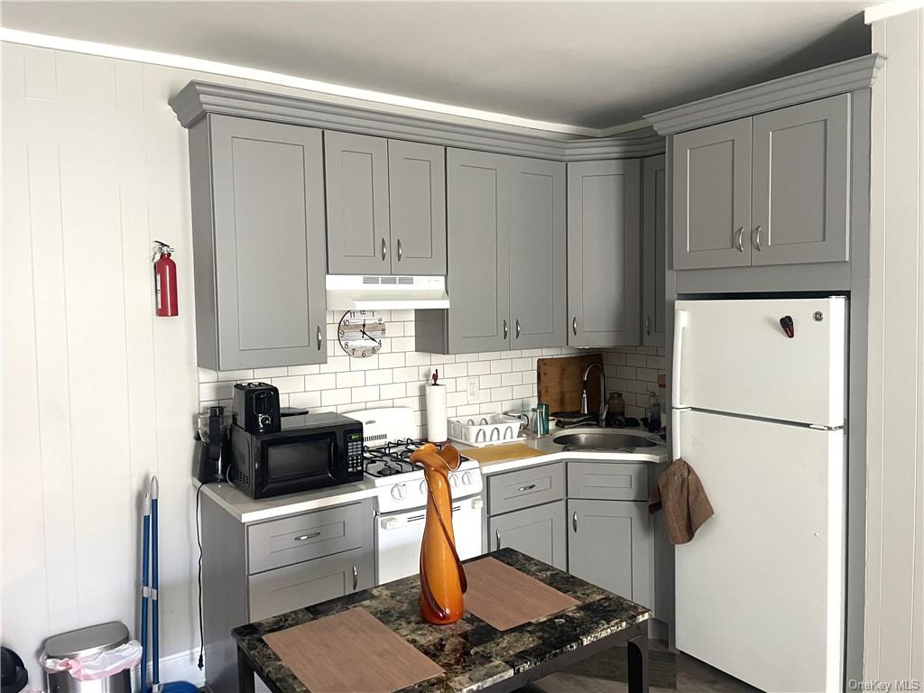 a kitchen with a refrigerator a stove a microwave and cabinets