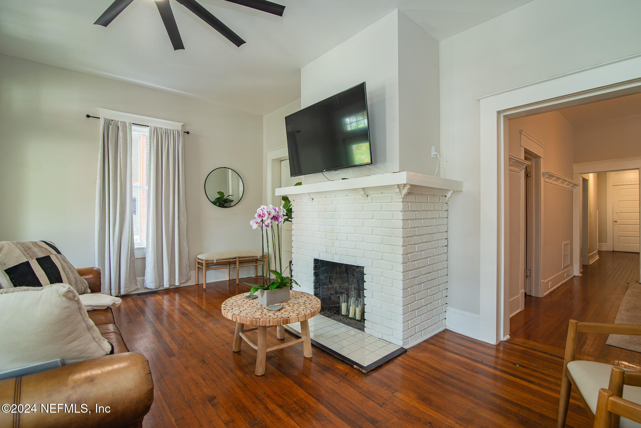 a living room with furniture a flat screen tv and a fireplace