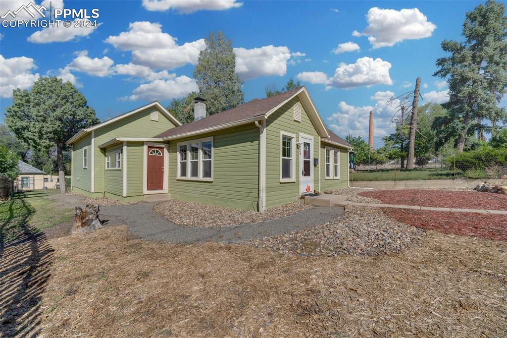 a view of a house with a backyard and garden