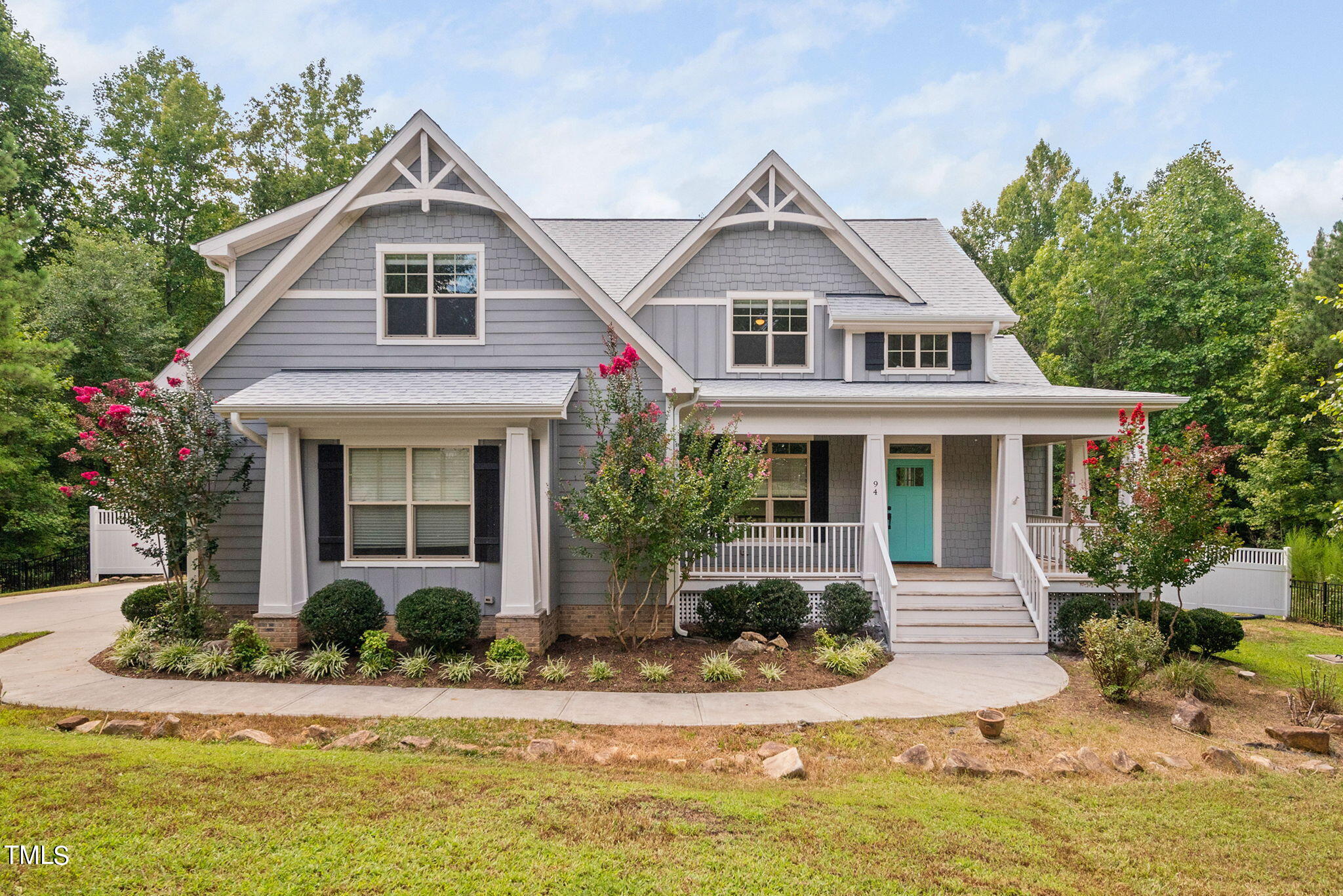 a front view of a house with a yard outdoor seating and garage